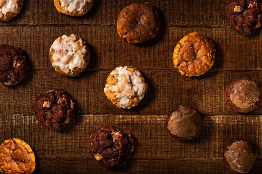 Fresh baked cookies and pastries styled on a dark surface