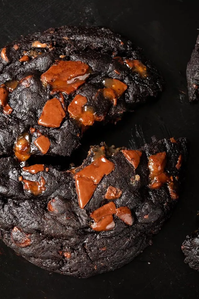 Fresh baked cookies and pastries styled on a dark surface
