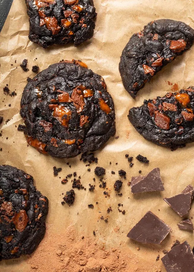 Fresh baked cookies and pastries styled on a dark surface
